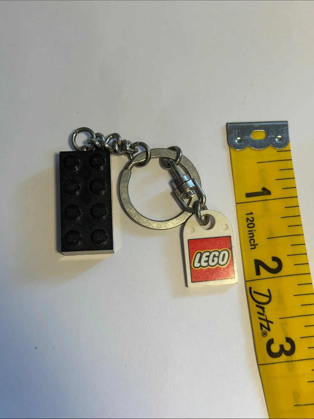 Lego Black Brick Keychain with White and Red Logo Tag